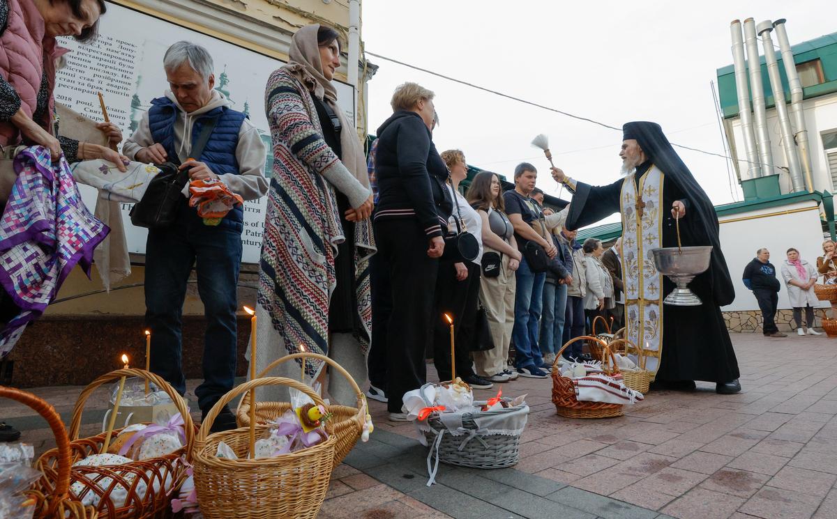 A Ukrainian priest blesses believers at the St. Feodosia Monastery in Kyiv, Ukraine, 19 April 2025. Photo: EPA-EFE / SERGEY DOLZHENKO
