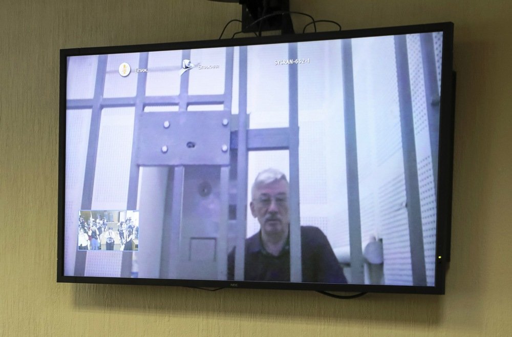 Jailed human rights activist Oleg Orlov is seen on TV screen as he participates in a court appeal hearing via video link from his prison against his sentence at the Moscow City Court in Moscow, Russia, 11 July 2024. Photo: EPA-EFE/MAXIM SHIPENKOV