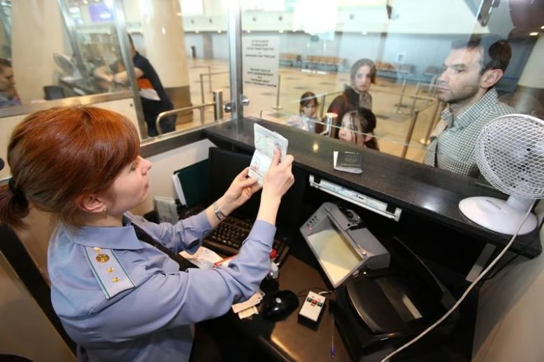 An immigration officer checks a passport at Moscow’s Sheremetyevo Airport. Photo: Flickr