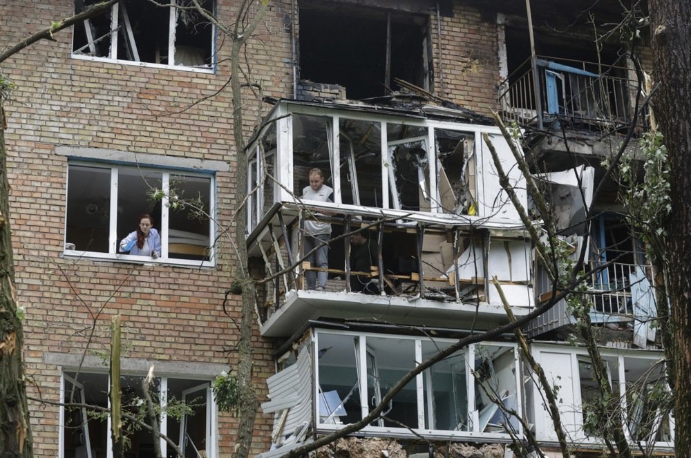 Residents clear debris at the site of a nine-storey residential building struck by a drone in Kyiv, Ukraine, 24 May 2025. Photo: EPA-EFE/SERGEY DOLZHENKO
